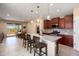 Open concept kitchen featuring a granite island, stainless steel appliances and barstool seating at 26725 W Marco Polo Rd, Buckeye, AZ 85396