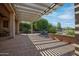 Inviting covered patio with stylish pergola, perfect for outdoor entertaining, and desert landscaping at 26725 W Marco Polo Rd, Buckeye, AZ 85396
