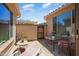 Private patio featuring outdoor dining, potted plants, lounge chairs, and privacy walls at 26725 W Marco Polo Rd, Buckeye, AZ 85396