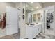 Bathroom with a vanity, large mirrors, stylish accents, and easy access to the walk-in closet at 2835 E Donald Dr, Phoenix, AZ 85050