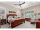 Inviting bedroom with a wooden bed frame, neutral tones, and plantation shutters for natural light at 2835 E Donald Dr, Phoenix, AZ 85050