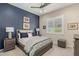 Bedroom showcasing a navy accent wall, a window with shutters, and a plush, inviting bed at 2835 E Donald Dr, Phoenix, AZ 85050