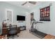 Versatile room with a treadmill, desk area, and natural light from plantation shutters at 2835 E Donald Dr, Phoenix, AZ 85050