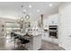 Bright, open kitchen with white cabinets, stainless steel appliances, and a large center island at 2835 E Donald Dr, Phoenix, AZ 85050