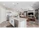Open concept kitchen featuring a large island, stainless steel appliances, and views into the living area at 2835 E Donald Dr, Phoenix, AZ 85050