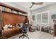 Office space featuring a built-in desk with shelving and a comfortable reading chair with a fan at 2835 E Donald Dr, Phoenix, AZ 85050