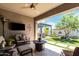 Covered patio space with comfortable seating, an outdoor tv, and views of the backyard at 2835 E Donald Dr, Phoenix, AZ 85050