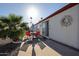 Back patio with outdoor seating, palm tree, and sunny skies at 303 S Recker Rd # 29, Mesa, AZ 85206