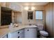 Well-lit bathroom featuring a vanity with ample counter space and a separate toilet area at 303 S Recker Rd # 29, Mesa, AZ 85206