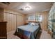 Comfortable bedroom with good-sized closet, carpeted floor, and paneled walls at 303 S Recker Rd # 29, Mesa, AZ 85206