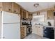 The kitchen includes appliances, wood cabinets, and sink for a functional and efficient cooking space at 303 S Recker Rd # 29, Mesa, AZ 85206