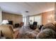 Cozy living room features comfortable seating, wood-paneled walls, and carpeted flooring at 303 S Recker Rd # 29, Mesa, AZ 85206