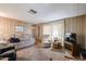 The living room features carpeted floors and neutral wood paneled walls offering a comfortable and relaxing living space at 303 S Recker Rd # 29, Mesa, AZ 85206