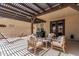 Comfortable covered back patio with wood furnishings, string lights, and a hammock to enjoy time outdoors at 3109 N Black Rock Rd, Buckeye, AZ 85396