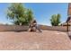 Enjoy the backyard amenities with a playset and covered patio at 3109 N Black Rock Rd, Buckeye, AZ 85396