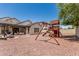 Spacious backyard includes a playset, firepit, and covered patio, great for outdoor fun at 3109 N Black Rock Rd, Buckeye, AZ 85396