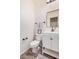 Modern half bathroom with white vanity, black hardware, and a square mirror at 3109 N Black Rock Rd, Buckeye, AZ 85396