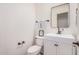 Well-lit half bathroom with a white vanity, rectangular mirror, and modern fixtures at 3109 N Black Rock Rd, Buckeye, AZ 85396