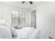 Inviting bedroom featuring a ceiling fan and a large window providing ample natural light at 3109 N Black Rock Rd, Buckeye, AZ 85396