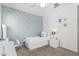 Cozy bedroom with a unique accent wall, a comfortable bed, and stylish decor at 3109 N Black Rock Rd, Buckeye, AZ 85396