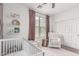 Bright bedroom featuring accent wall, views to the outdoors and stylish decor at 3109 N Black Rock Rd, Buckeye, AZ 85396