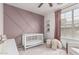 Charming bedroom with crib and designer paint, as well as views to the outdoors at 3109 N Black Rock Rd, Buckeye, AZ 85396