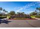Well-manicured entrance to Heritage Swim Park, featuring lush landscaping and clear signage at 3109 N Black Rock Rd, Buckeye, AZ 85396