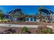 Community pool featuring lounge chairs and shaded seating areas, surrounded by palm trees and greenery at 3109 N Black Rock Rd, Buckeye, AZ 85396