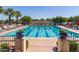 Gorgeous community pool featuring lap lanes, lounge chairs, and blue and white pennant banner at 3109 N Black Rock Rd, Buckeye, AZ 85396
