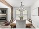 Charming dining room boasts a rustic wooden table, six chairs, and modern chandelier lighting at 3109 N Black Rock Rd, Buckeye, AZ 85396