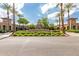 Stunning exterior of the Verado Golf Club entrance with palm trees and meticulously kept landscaping at 3109 N Black Rock Rd, Buckeye, AZ 85396