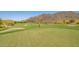 Expansive golf course with meticulously maintained green grass and picturesque desert scenery at 3109 N Black Rock Rd, Buckeye, AZ 85396
