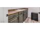 Laundry area with gray cabinets, a utility sink, and a woven storage basket at 3109 N Black Rock Rd, Buckeye, AZ 85396