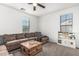 Relaxing living room featuring a comfortable sectional sofa, a rustic coffee table, and a window at 3109 N Black Rock Rd, Buckeye, AZ 85396