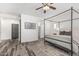 Calm and spacious main bedroom with a four-poster bed and ample natural light at 3109 N Black Rock Rd, Buckeye, AZ 85396