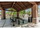 Open air brick pavilion with seating and a metal table offers a comfortable gathering spot for the community to enjoy at 3109 N Black Rock Rd, Buckeye, AZ 85396