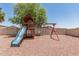 Backyard playground features a slide and swing set for hours of outdoor fun at 3109 N Black Rock Rd, Buckeye, AZ 85396
