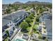 Community aerial view featuring rooftops with solar panels, a pool, green spaces, and mountain views at 3136 E Cheryl Dr, Phoenix, AZ 85028