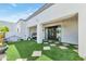 Backyard boasts artificial turf, pavers, a chandelier, and a cozy porch swing for relaxing at 3136 E Cheryl Dr, Phoenix, AZ 85028