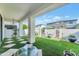Inviting backyard with artificial turf, outdoor seating, and elegant chandelier at 3136 E Cheryl Dr, Phoenix, AZ 85028