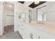 Sleek bathroom boasts double sinks, vanity, modern faucets and fixtures, and a walk-in closet view at 3136 E Cheryl Dr, Phoenix, AZ 85028