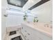 Bright bathroom with double sink vanity, modern faucets, black and white rugs, and plants at 3136 E Cheryl Dr, Phoenix, AZ 85028