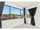 Bright bedroom featuring neutral carpet, a large window with neighborhood and mountain views, and black curtains at 3136 E Cheryl Dr, Phoenix, AZ 85028