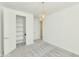 Bright bedroom featuring plush carpet, walk-in closet, and contemporary lighting fixture at 3136 E Cheryl Dr, Phoenix, AZ 85028