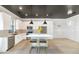 Modern kitchen featuring white cabinets, stainless appliances, a kitchen island, and modern pendant lighting at 3136 E Cheryl Dr, Phoenix, AZ 85028