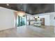 Bright open-concept with wood floors, modern light fixture, a kitchen island and stainless appliances enhance this space at 3136 E Cheryl Dr, Phoenix, AZ 85028