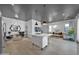 Bright open-concept living room showcasing a kitchen island, hardwood floors, and stylish furnishings at 3136 E Cheryl Dr, Phoenix, AZ 85028
