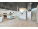 Open-concept with stainless appliances, a kitchen island, light fixture and view to the staircase enhances this space at 3136 E Cheryl Dr, Phoenix, AZ 85028