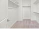 Walk-in closet with plush carpet, adjustable shelving, and chrome bars for hanging clothing at 3136 E Cheryl Dr, Phoenix, AZ 85028