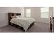 Cozy bedroom with carpet flooring and large window for ample natural light at 36463 W San Alvarez Ave, Maricopa, AZ 85138
